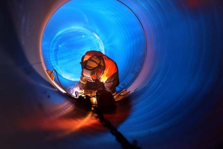 Welder inside a large pipe